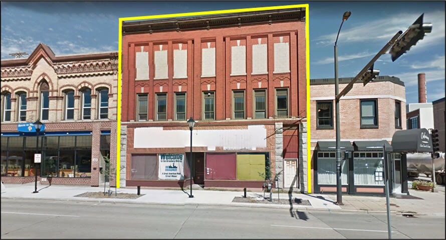 Vacant brick storefront building on Dousman Street in Green Bay